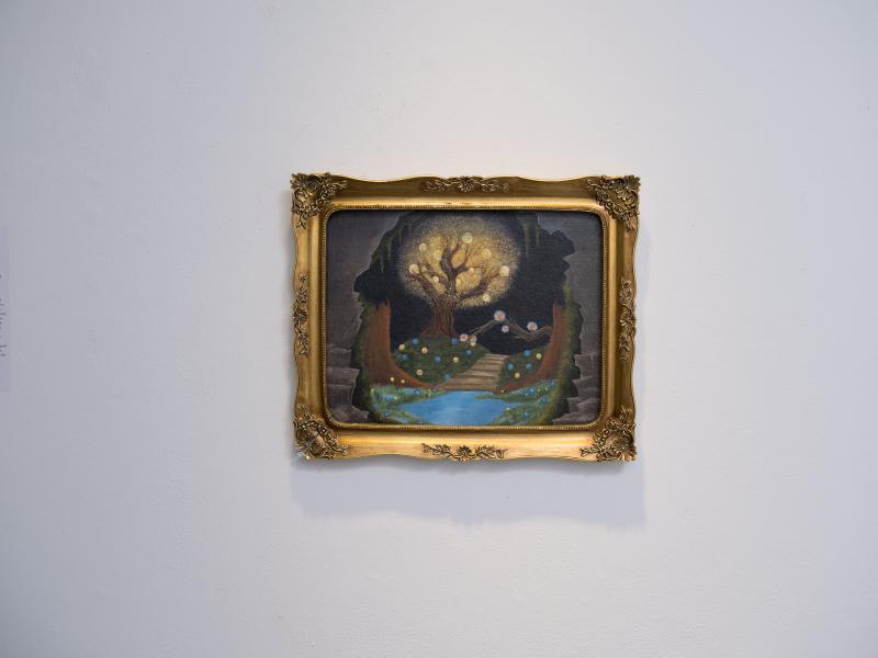 detail image of an installed small, framed painting