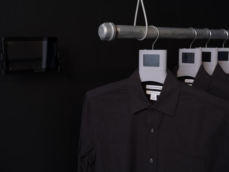 detail image of multiple shirts on hangers with digital displays