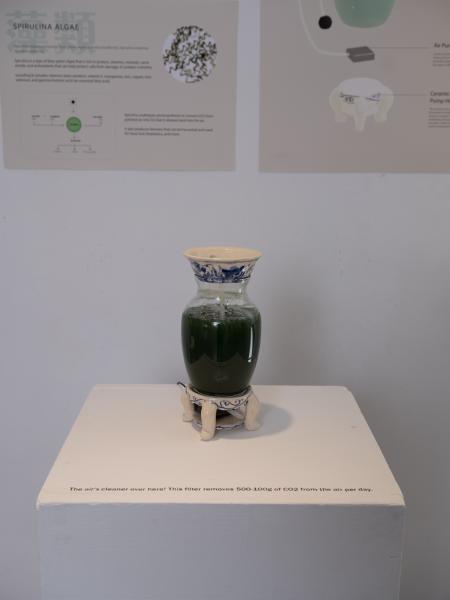 detail of an installed glass jar with green liquid and a water pump