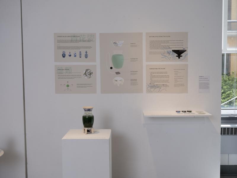 installation of graphics and a glass jar containing green liquid