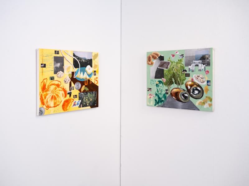 two mixed media paintings installed in a corner of a gallery