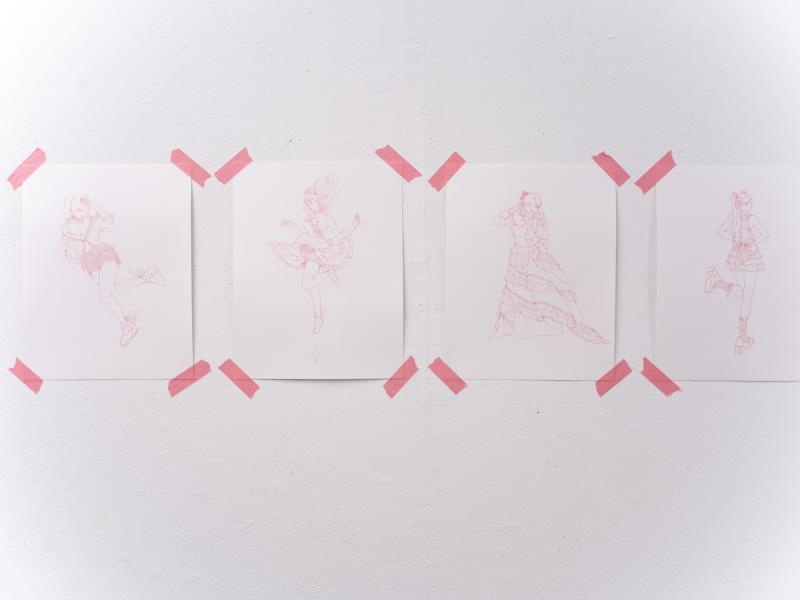 detail image of multiple small drawings installed on a gallery wall 