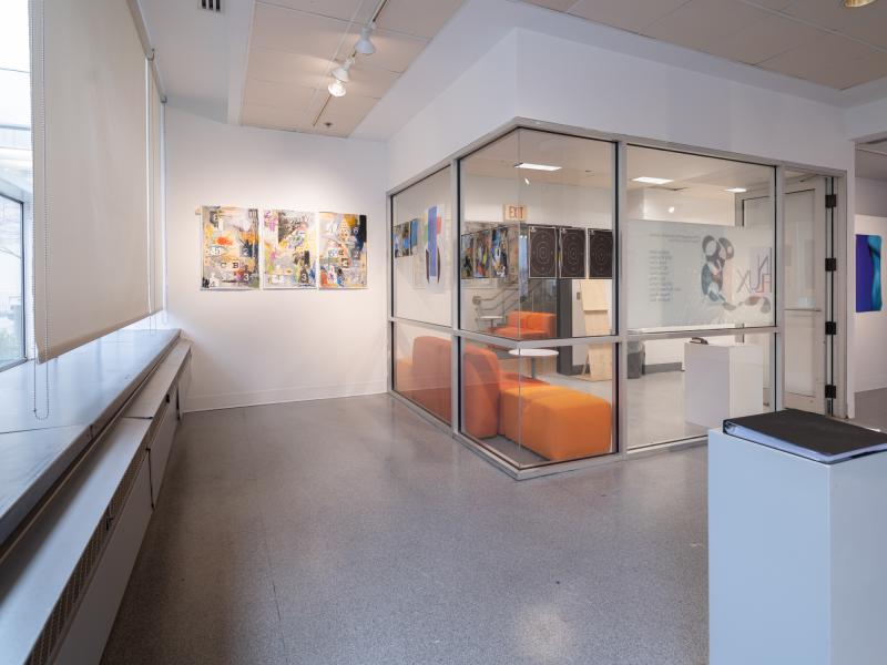 image of mixed media work installed on the walls and gallery glass