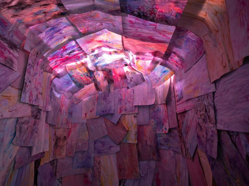 detail image of an installation using multiple works on paper installed on the walls and ceiling of a gallery