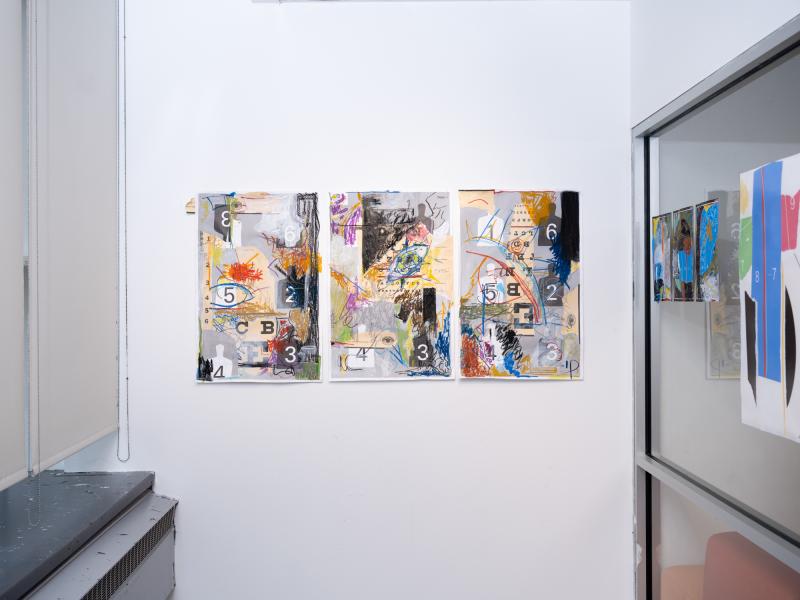 image of mixed media work installed on the walls and gallery glass