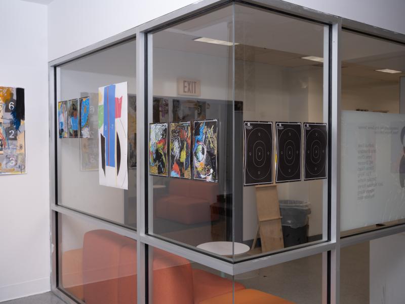 image of mixed media work installed on the walls and gallery glass