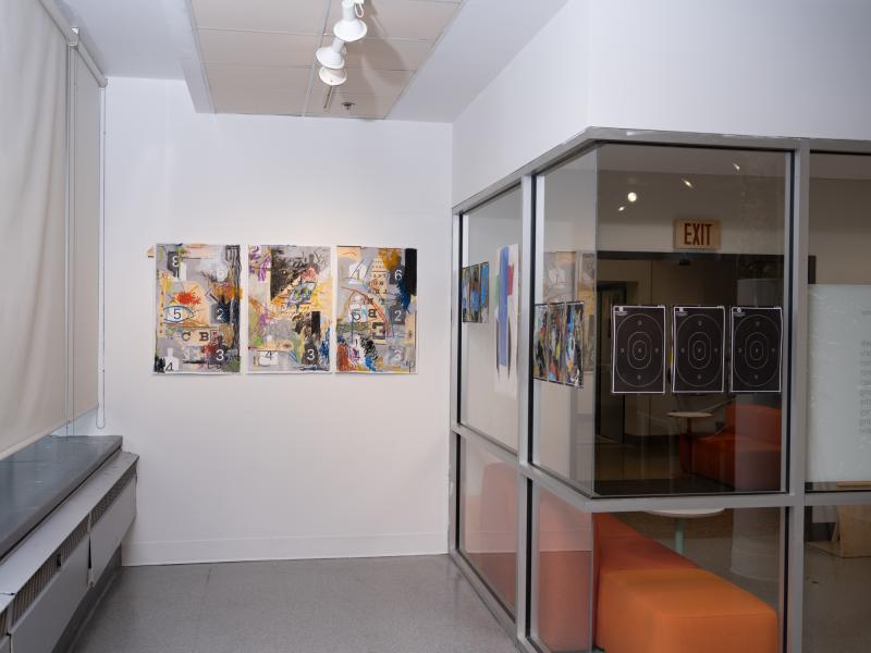 image of mixed media work installed on the walls and gallery glass