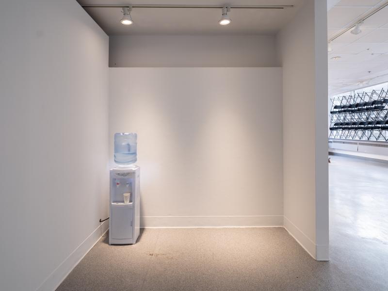 installation image of a water cooler in a gallery nook and installation with chairs