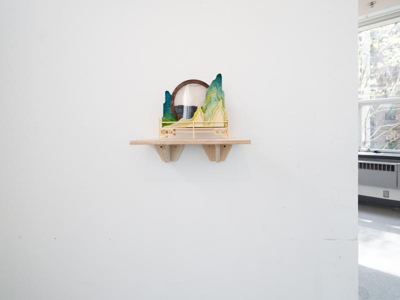 installation of a mixed media sculpture installed on a shelf