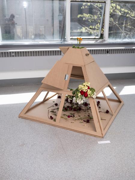 mixed media sculpture installed on the floor of a gallery