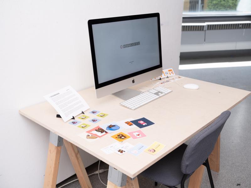 detail image of a monitor installed on a desk with pamphlets