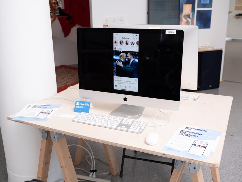 installation of a monitor displaying an app and pamphlets installed on a desk