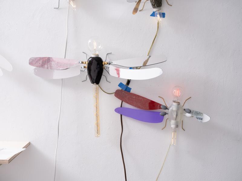 detail image of mixed media pieces installed on a gallery wall