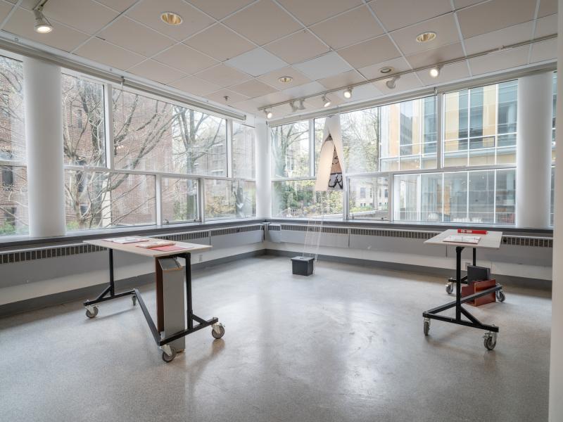 mixed media sculptures installed on tables and the gallery window