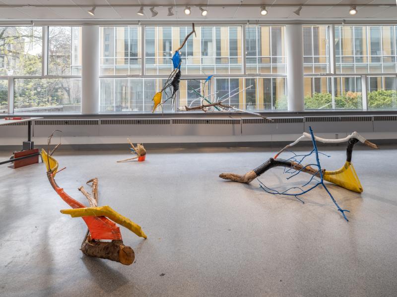 multiple floor sculptures installed on a gallery floor and window sill