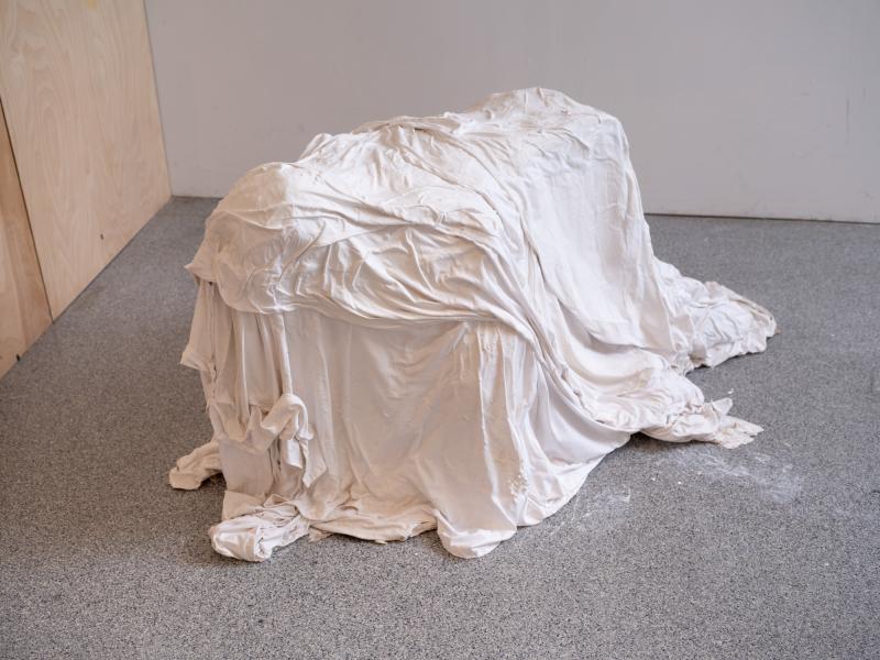 a mixed media floor piece installed in a gallery