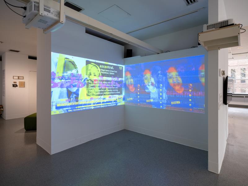 installation image of a dual projection in the corner of a gallery