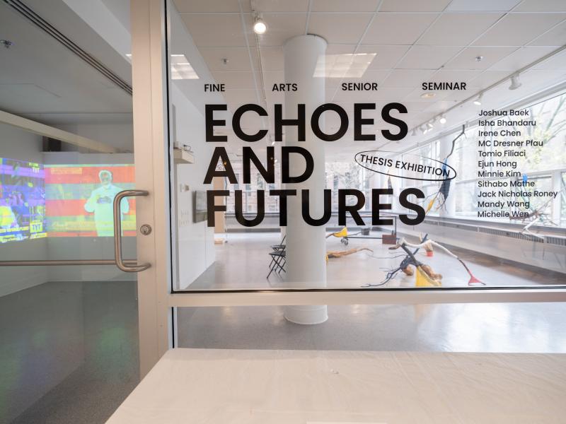 exhibition title installed on the entry glass of a gallery