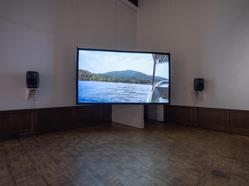 installation image of digital video projected on a hanging screen