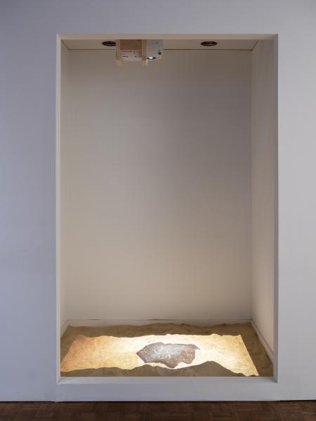 installation image showing a digital projection on the floor of a gallery