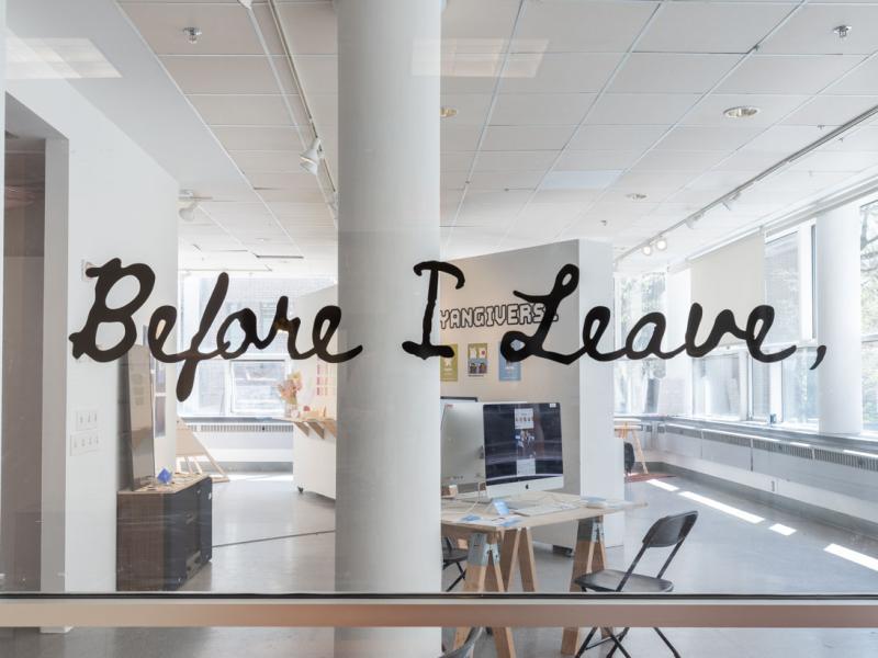 exhibition title installed on the entry window of a gallery