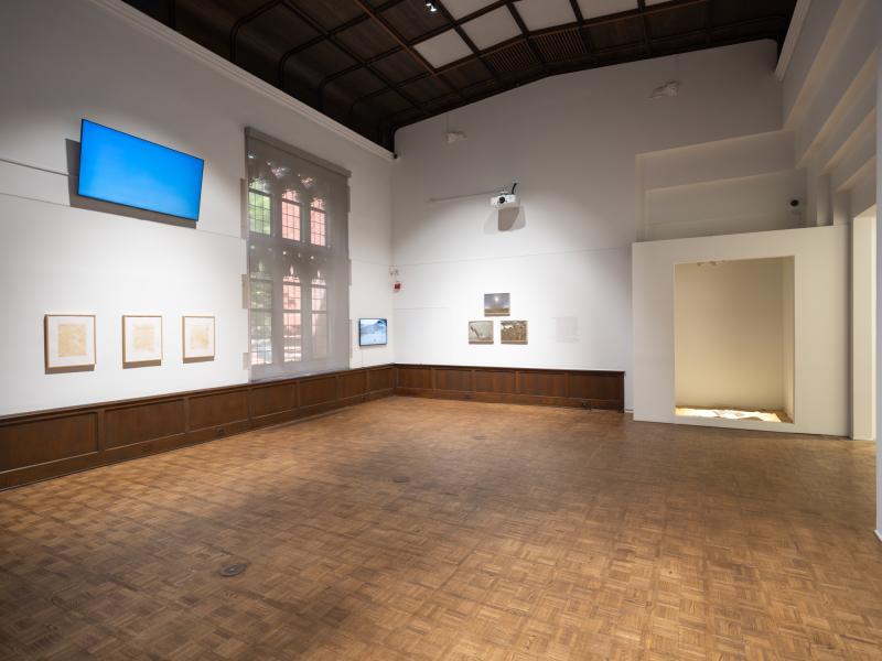 installation image with multiple sculptures, prints, and digital video
