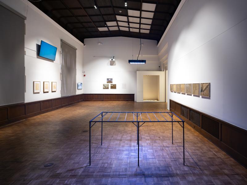 installation image with multiple sculptures, prints, and digital video