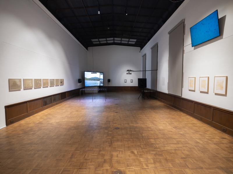 installation image with multiple sculptures, prints, and digital video