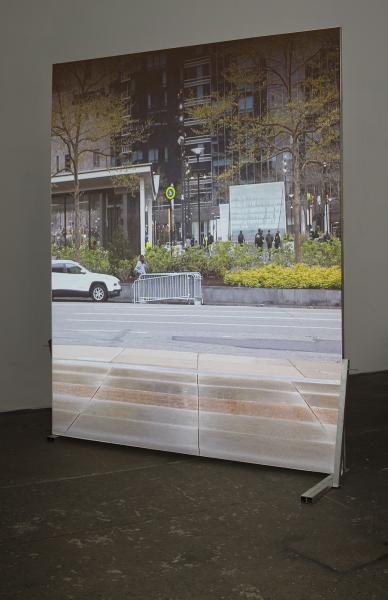 image of a large projection on a freestanding screen of an empty plaza