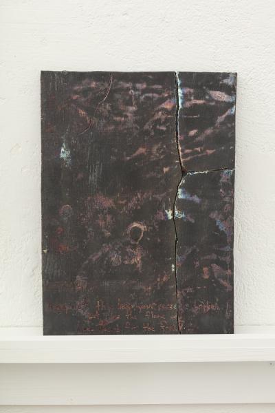 image of a darkly glazed ceramic piece on a shelf mounted to the wall