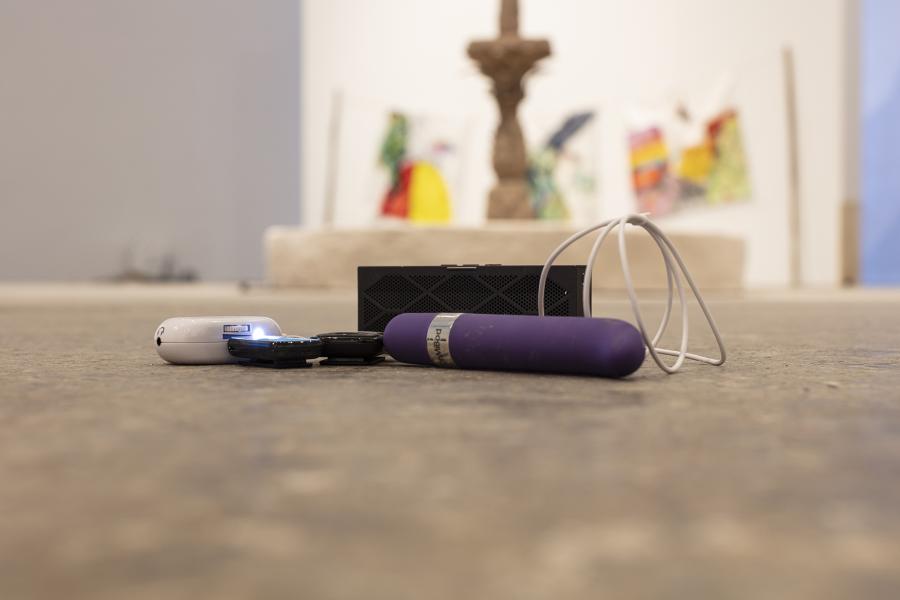 image of a floor sculpture using a purple vibrator, small audio speaker, and audio devices