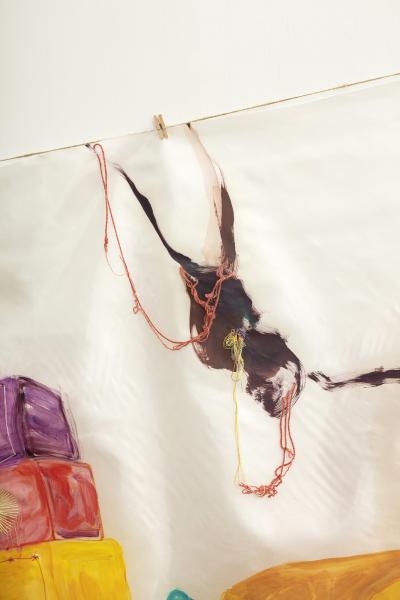 detail image of a painting on silk suspended on a thin cord