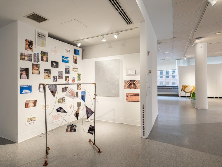 installation image of multiple photographs and sculpture in a gallery