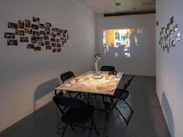 table with recipe cards, photos installed on exterior walls, and projection in rear