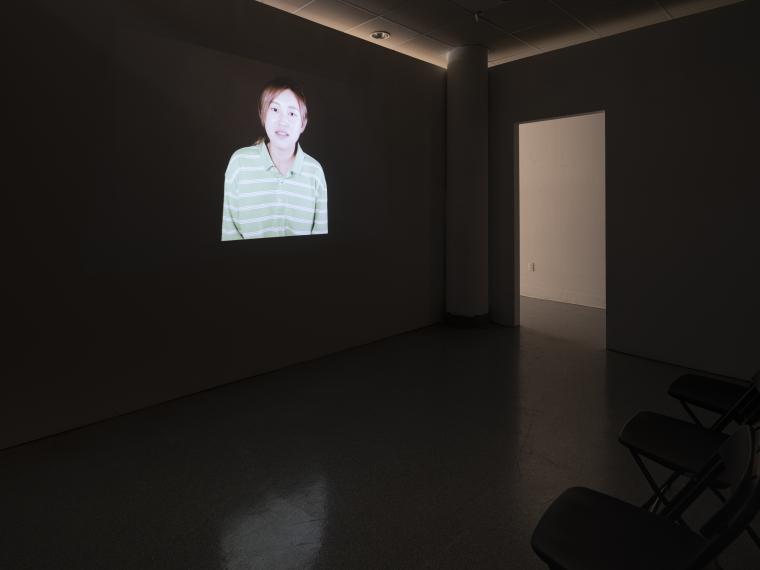 projected image in a dark gallery setting