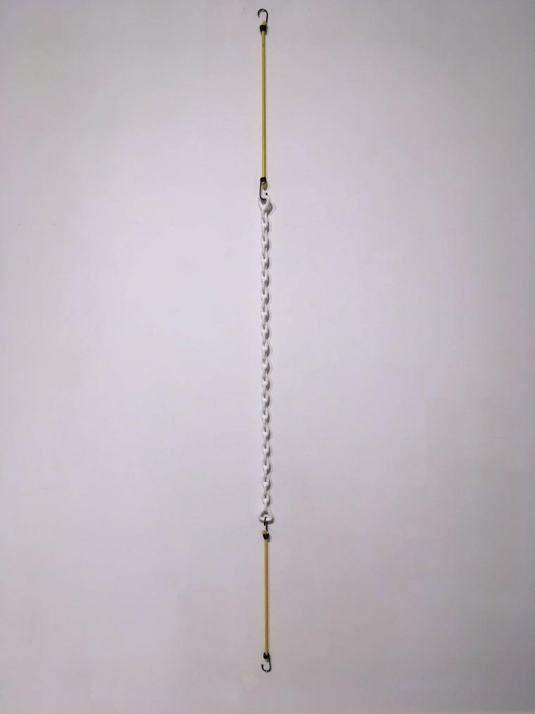 wall sculpture using yellow bungee cords stretching a white plastic coated chain 