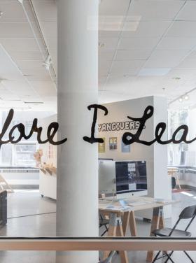 exhibition title installed on the entry glass of a gallery